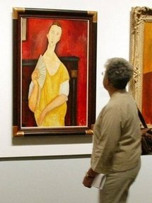 A photo taken on 21st May 2004 shows a visitor looking at the painting 'La Femma à l'éventail' (Woman with a Fan) by Amedeo Modigliani during an exhibition at The Jewish Museum in New York. A photo taken on 21st May 2004 shows a visitor looking at the painting 'La Femma à l'éventail' (Woman with a Fan) by Amedeo Modigliani during an exhibition at The Jewish Museum in New York.