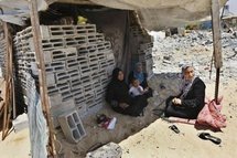 A Palestinian family sits in a makeshift shelter after its home was demolished by Hamas security forces in Rafah on 19th May. A Palestinian family sits in a makeshift shelter after its home was demolished by Hamas security forces in Rafah on 19th May.