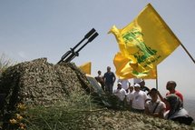 Lebanese tourists look at a Hezbollah anti-aircraft gun.