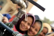 Egyptian girls queue at a water cistern to fill their containers with clean water at al-Rahawe village. Egyptian girls queue at a water cistern to fill their containers with clean water at al-Rahawe village.