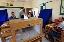 An Egyptian woman casts her vote at a voting station in Cairo.