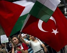 Young women wave the national flags of Turkey and Palestine during a rally in New York, on 1st June.