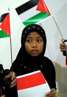 The daughter of a pro-Palestinian Indonesian activist waits to greet her father as he returns to Jakarta.