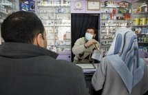 A Palestinian pharmacist serves customers in Gaza City.