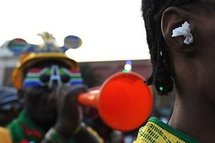 In Johannesburg, a fan wears paper ear plugs to block out the sound of a vuvuzela.