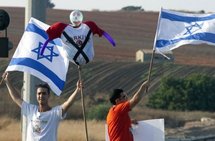 Israelis wave the national flag as they demonstrate in the coastal city of Netanya.