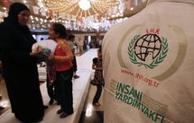 Palestinian women and children attend an event organized by Turkish Muslim charity IHH.