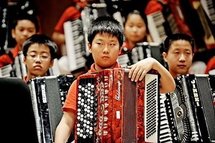 A boy holds his accordion during the opening of 'Fete de la Musique' in Shanghai. A boy holds his accordion during the opening of 'Fete de la Musique' in Shanghai.