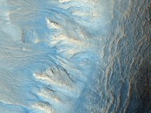 The west-facing side of an impact crater in the mid-latitudes of Mars' northern hemisphere. The west-facing side of an impact crater in the mid-latitudes of Mars' northern hemisphere.