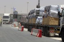 Trucks carrying wood bound for the Gaza Strip wait at the Kerem Shalom terminal.