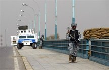 Iraqi police commandos guard a bridge in Baghdad.