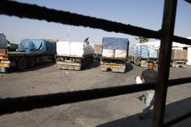 A Palestinian worker checks a truck carrying supplies after its arrival in Rafah town.