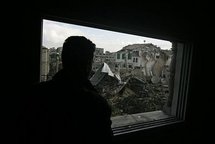 A Palestinian man looks at ruins following an Israeli air strike in the Bureij refugee camp, central Gaza Strip, in December 2008.