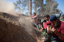 Libya rebels battle in plains south of Tripoli Libya rebels battle in plains south of Tripoli