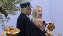 Topless Femen activist grabs Baby Jesus in St Peter's Square