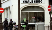 Charlie Hebdo marks anniversary edition with gun-wielding God