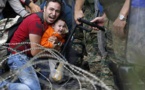 Barbed wire and stun grenades welcome refugees to Macedonia